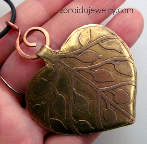 Cut from brass sheet, etched with my own design and form into a pendant with copper bail 